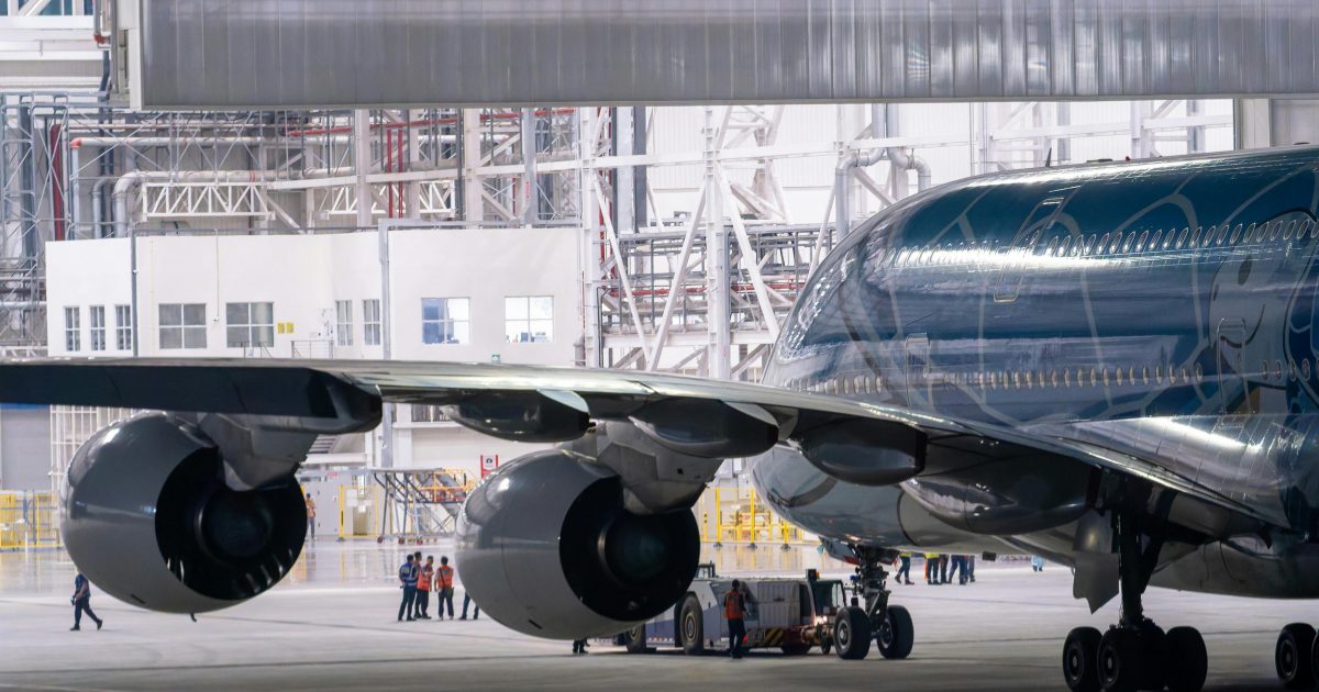 Widebody aircraft undergoing maintenance in an MRO hangar